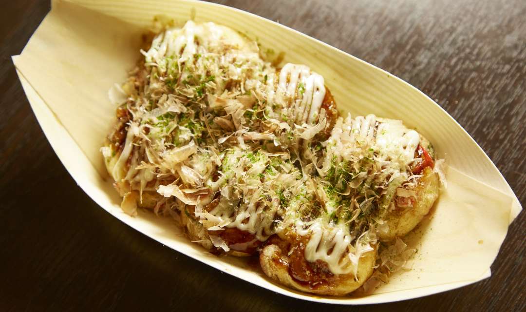 takoyaki in a bowl on a table