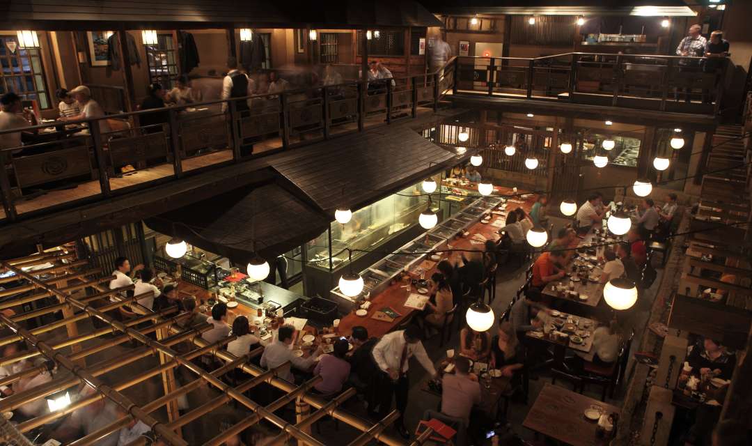 A busy restaurant at night shot from a high angle