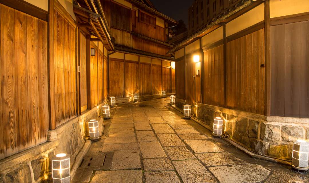 Night view of a pedestrianised street lined with lanterns