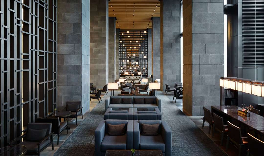 a hotel lounge with grey sofas