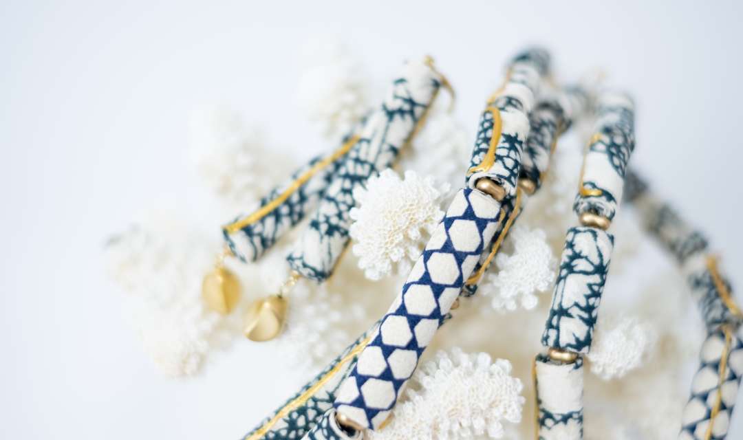 Fabric beads wrapped around a piece of coral