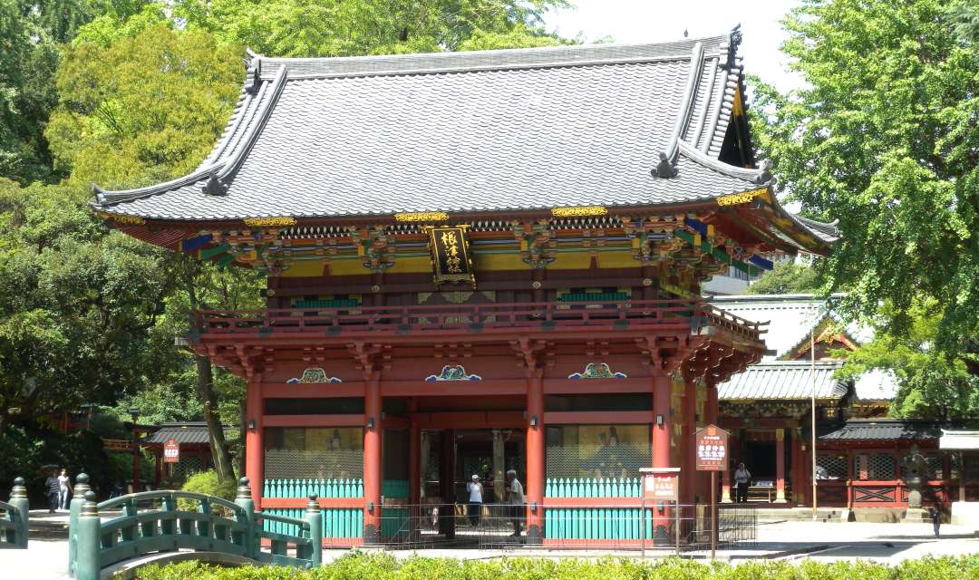 a big shrine gate surrounded by trees