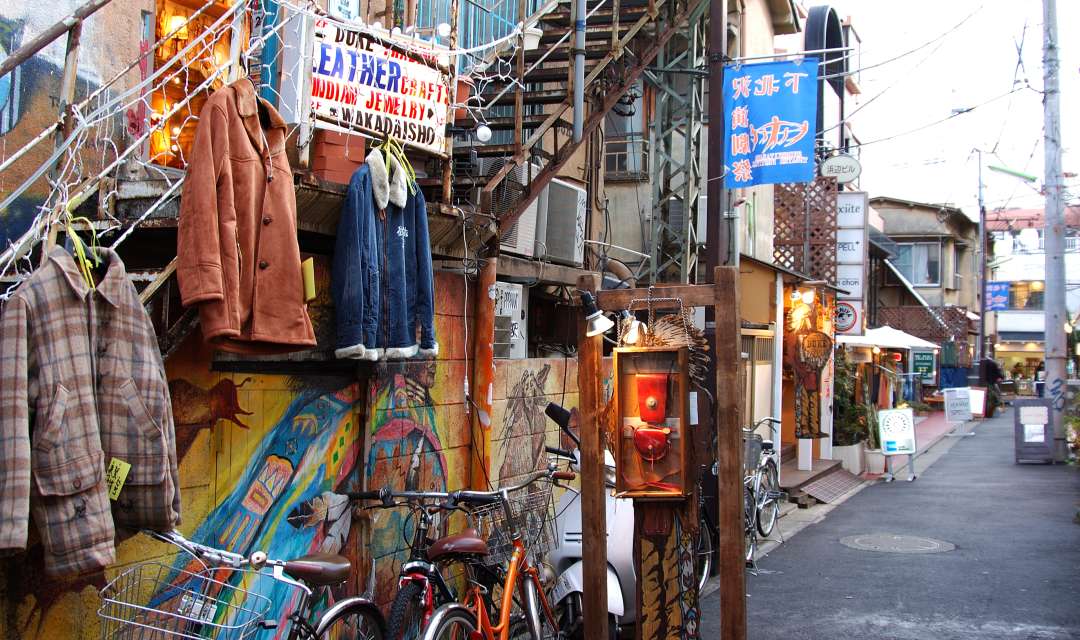 the outside of a shop with jackets on display