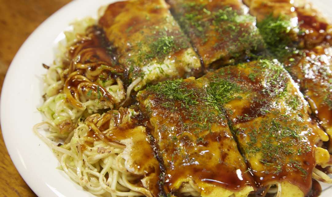 okonomiyaki on a plate on a table