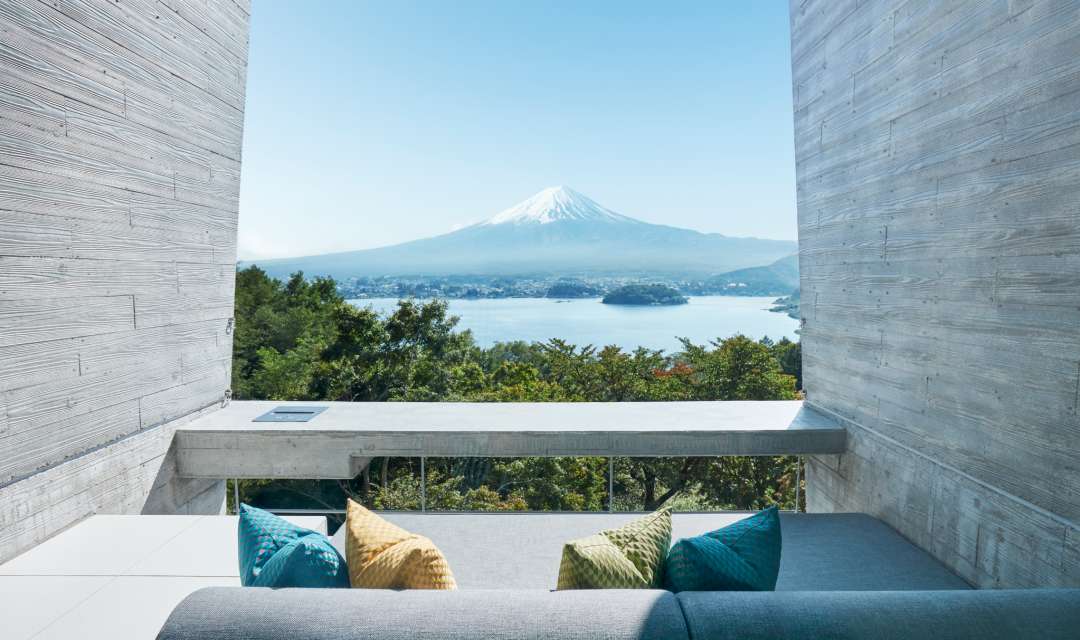 sofa on a terrace overlooking a lake and mountain