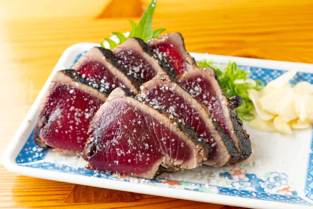 Slices of seared bonito on a plate at Hirome Market, Kochi Prefecture