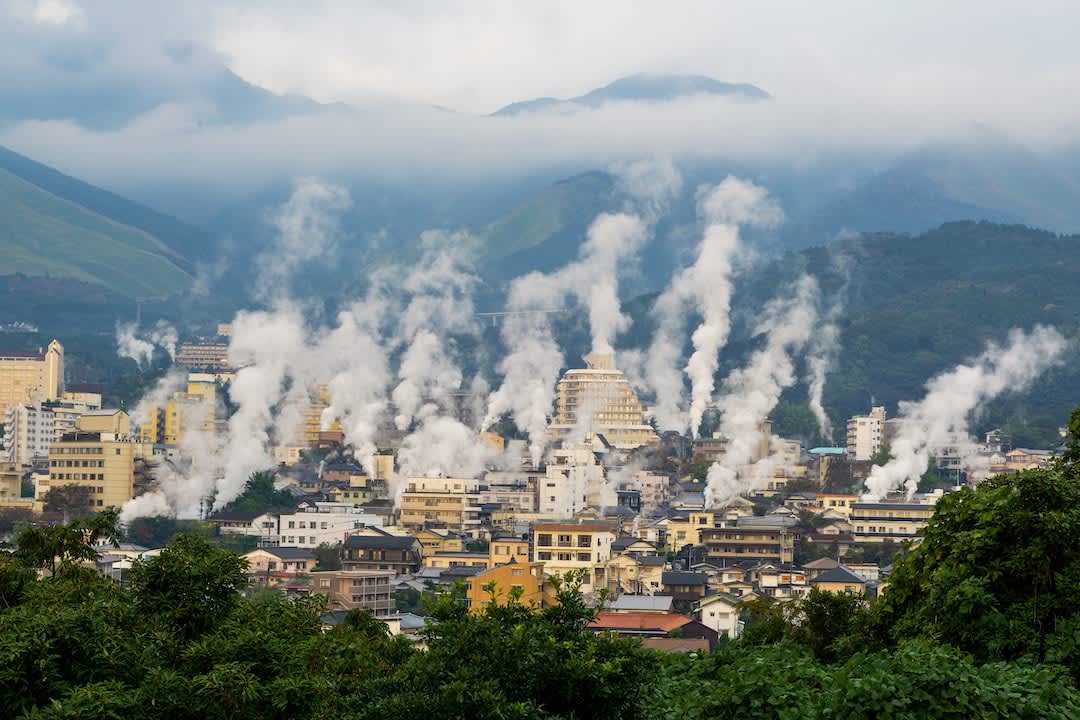 The onsen town of Beppu, Oita Prefecture with steam rising from the natural hot springs.