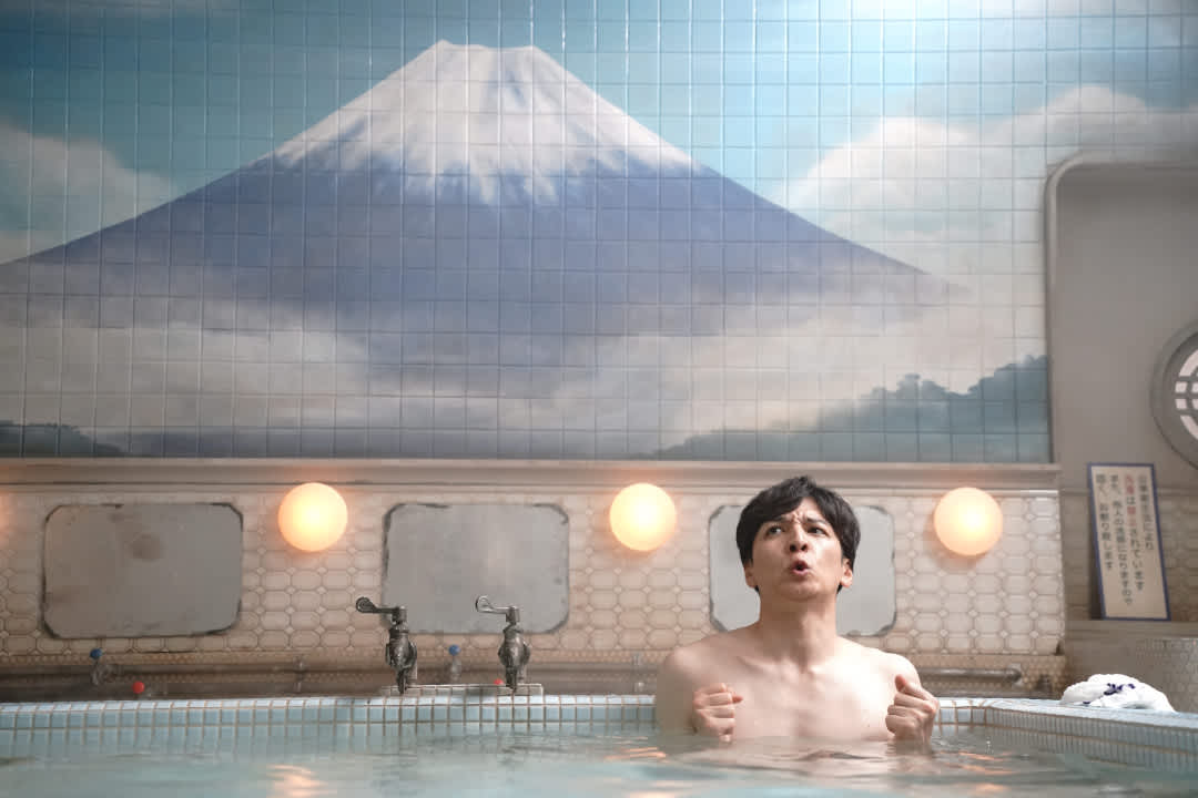 Promotional image for the film Yudo: The Way of the Bath, with a person sitting in a traditional Japanese bath