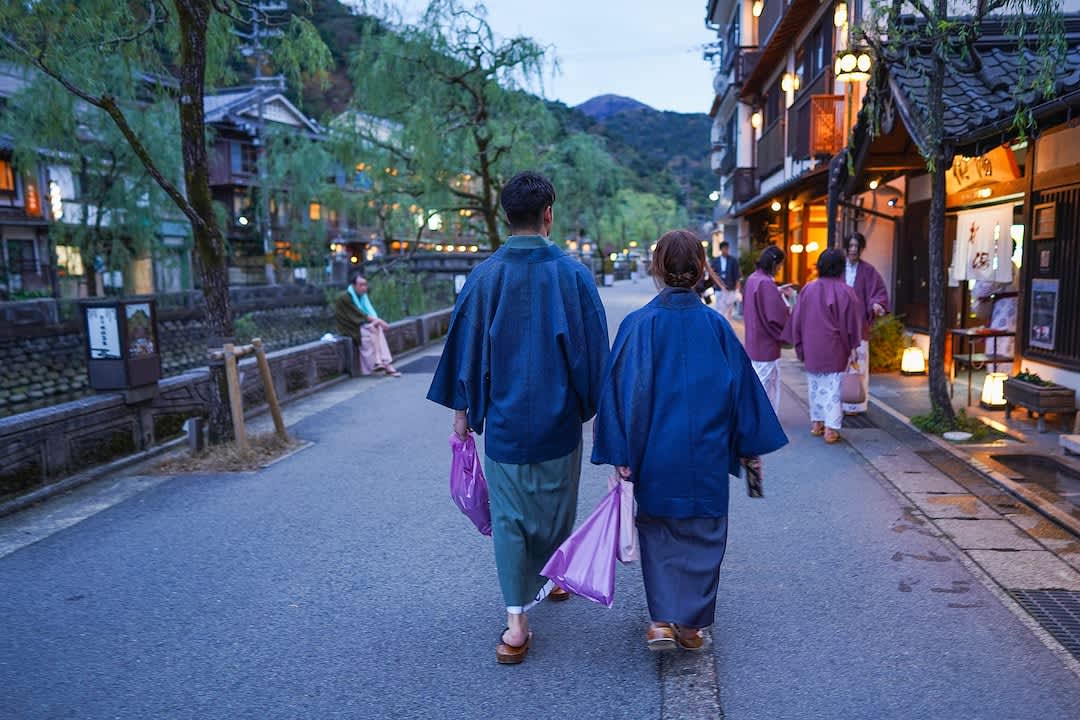 Japanese couple wearing yukata walking at Kinosaki Onsen, Hyogo Prefecture.