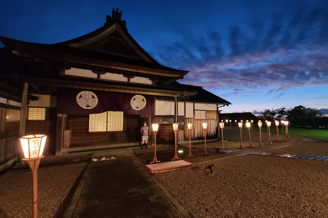 Traditional Japanese building on Sado Island, Niigata, at night with lanterns out the front