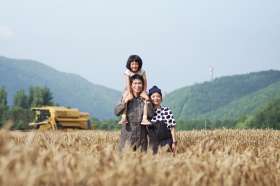 a family in the midst of crops at ezura farm