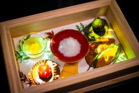 makes food on plates in TREE by NAKED yoyogi park art gastronomy cafe in Tokyo’s historic Yoyogi Park