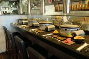 diners are set up with a one-person gas-fired brazier at counter seats