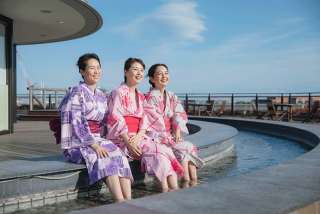opt for an open air bath at a hot spring facility by the bay