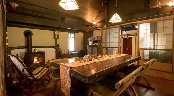 The dining room, beautifully restored and heated by a wood-burning stove.