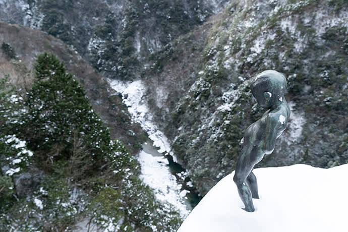 The “Peeing Boy of Iya Valley” stands looking over the Iya Valley.