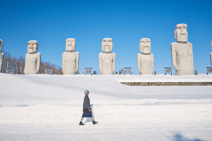 Moai statues line the main entrance to Makomanai Takino Cemetery.