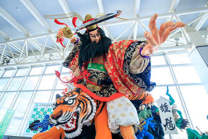 A dynamic figure from a Hachinohe Sansha Taisai festival float is on display at Hachinohe Station.