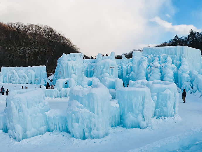 Ice sculptures sparkle blue in the sunlight.