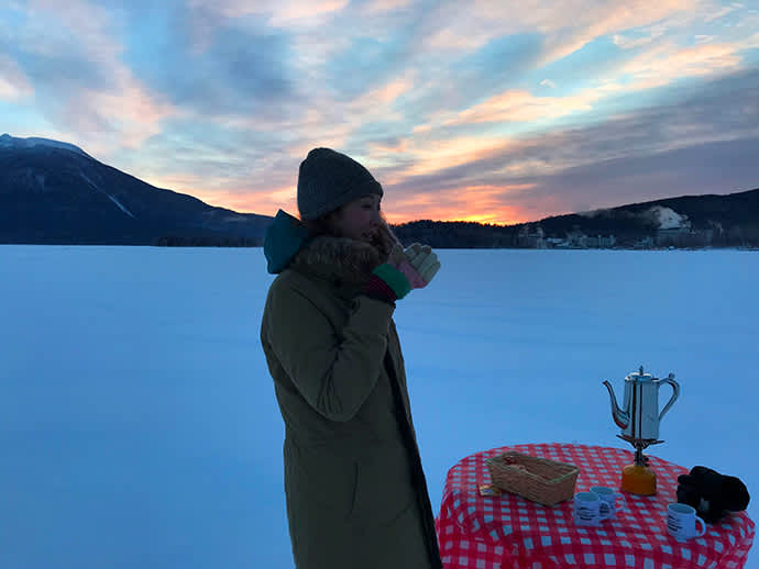 Drinking coffee in a dramatic frozen setting.