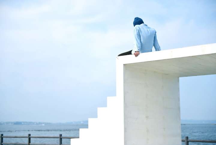 A man sit on East house