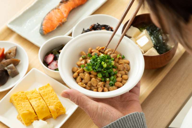 woman eating a meal with natto