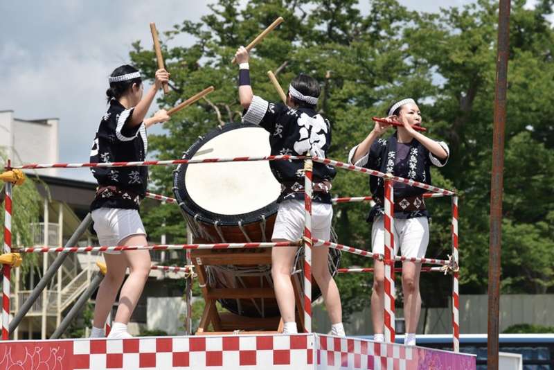 Performers play traditional instruments for visitors