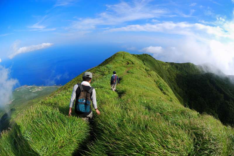 people hiking up mt. nishi at hachijojima