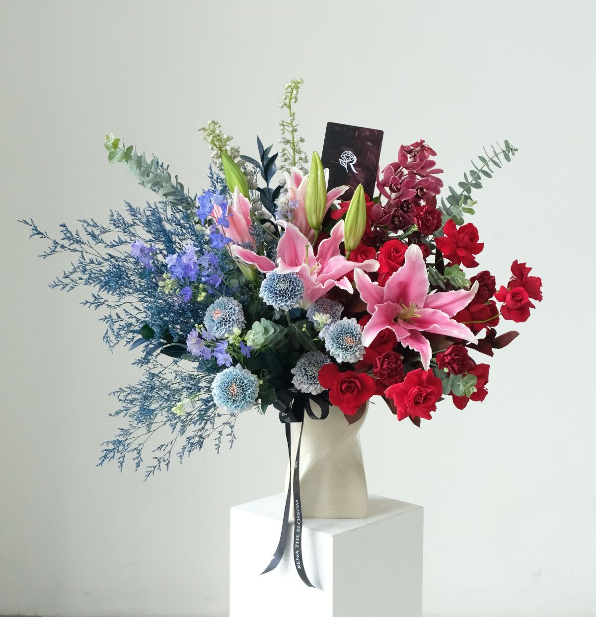 Solacing Moon - Red cymbidium, roses & pink lily with blue delphinium — solacing moonlight comfort. - Rena The Blossom Jakarta