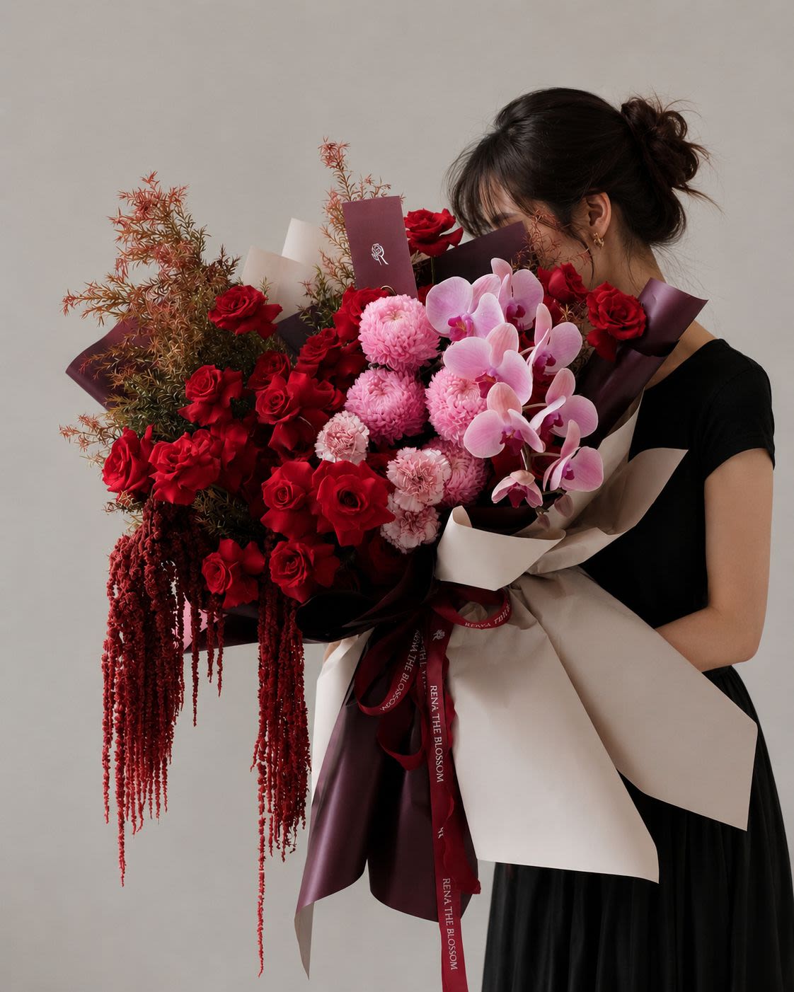 Woodland Rose - A romantic garden of deep red roses, cascading purple orchids, and soft pink peony mums, brought to life with delicate carnations and wild red accents. The flowing amaranthus and pine foliage add a natural, woodland-like texture, creating a bouquet that feels untamed, elegant, and quietly enchanting. - Rena The Blossom Jakarta