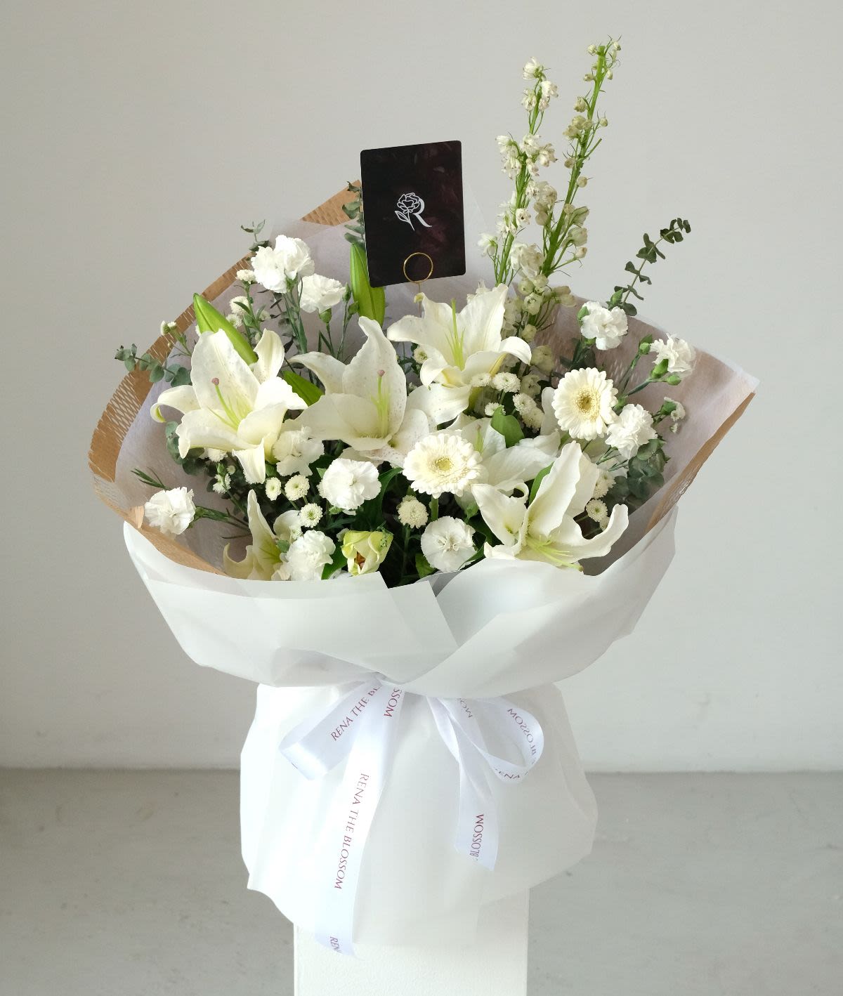 White Sonata - White lily, garbera & delphinium with carnation — pure white sonata. - Rena The Blossom Jakarta