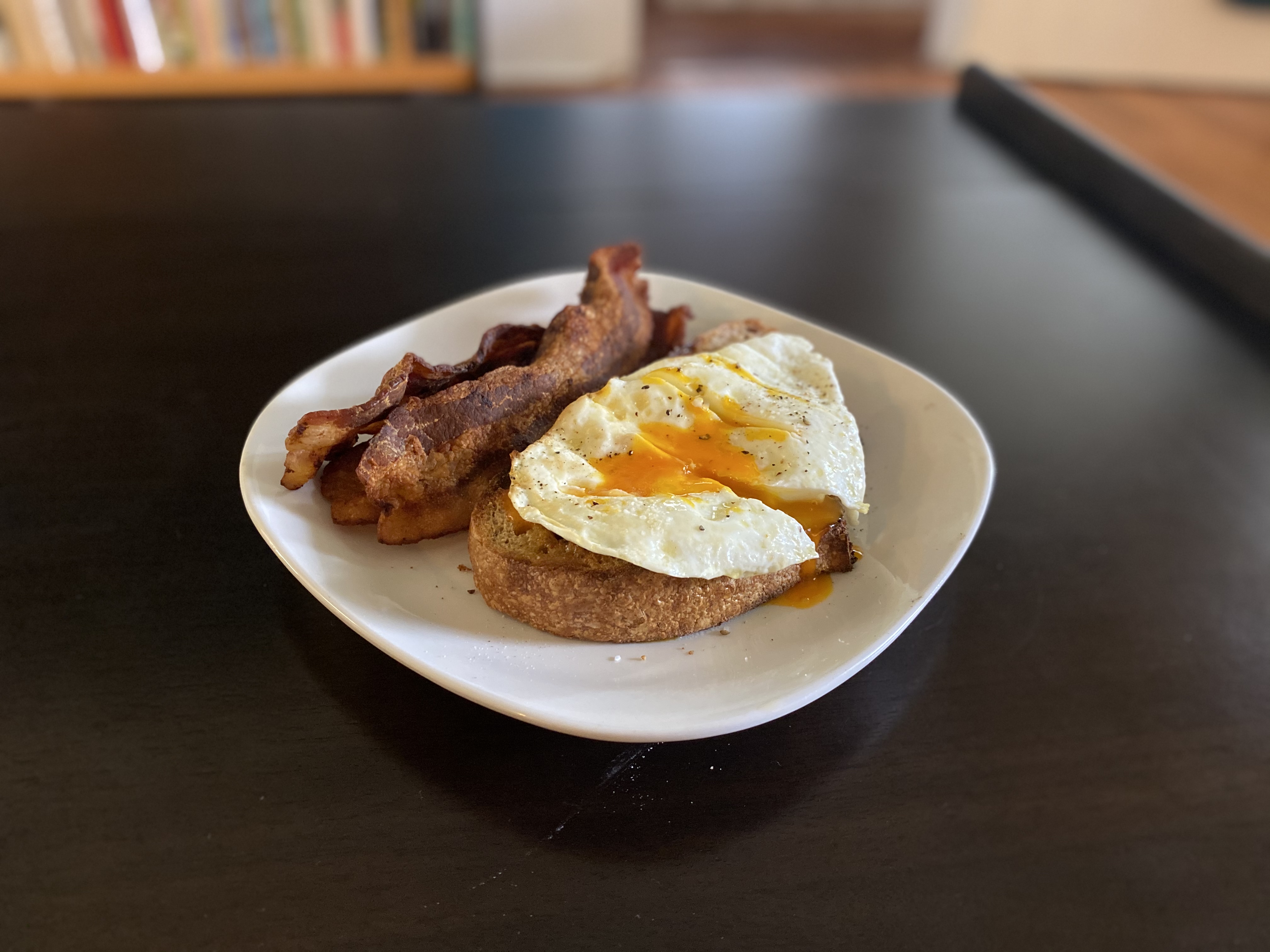 Fried egg on toast with a runny orange yolk