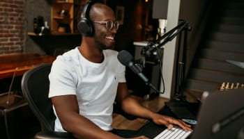 a person wearing headphones and sitting at a computer