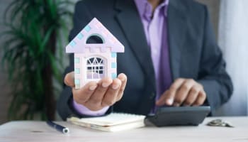 a person holding a small house