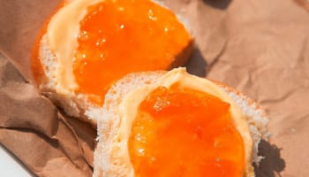 a piece of bread with orange jam