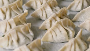 a group of dumplings on a white surface