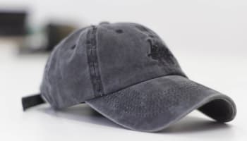 a black baseball cap on a white surface