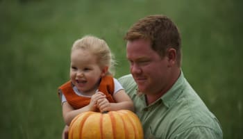 a person holding a child in his arms