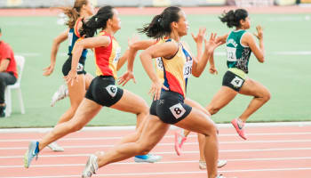 a group of women running on a track