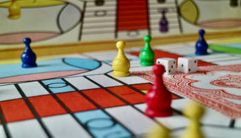 a game board with dice and game pieces
