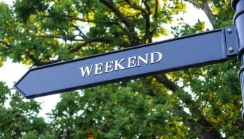 a street sign with trees in the background