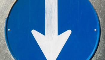 a blue sign with a white arrow