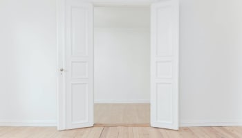 a white room with a door open