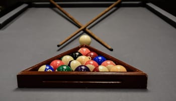 a pool table with balls and sticks