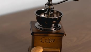 a wooden spoon next to a coffee grinder
