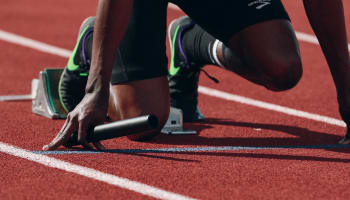 a person in a track with a baton