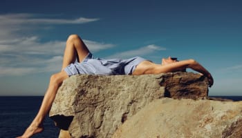 a person lying on a rock