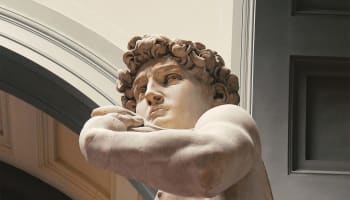 a statue of a person with his arms crossed