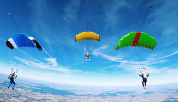 a group of people skydiving in the sky