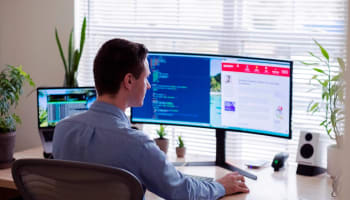 a person sitting at a desk with a computer